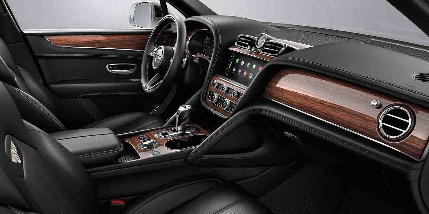 Bentley Beijing - Sanlitun Bentley Bentayga EWB interior with a Crown Cut Walnut veneer, view from the passenger seat over looking the driver's seat.
